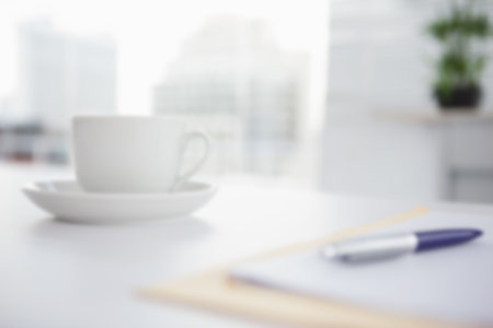 Cup with saucer on table by window