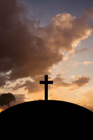 Cross religion symbol shape over sunset skyの写真素材