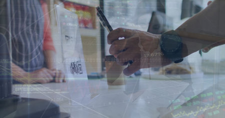 Scanning laptop QR code with hand holding smartphone stylus at office table, documents, coffee cup. Business, collaboration, technology, finance, teamwork, modern, corporateの写真素材