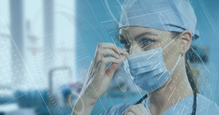 doctor wearing blue scrubs adjusting surgical mask in hospital, with stethoscope and schematics....