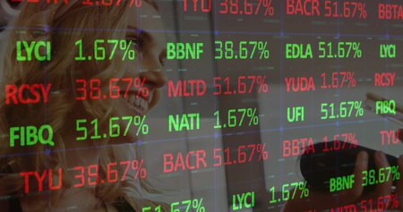Two colleagues in business attire analyzing stock tickers on digital screen in office, with stylus....