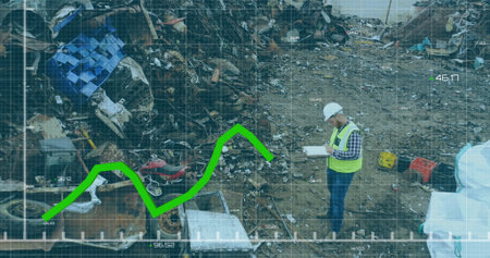 Inspecting man in safety vest holding clipboard at scrap yard, with line graph overlay, copy space. Industrial, construction, analytics, monitoring, machinery, safety, ruggedの写真素材