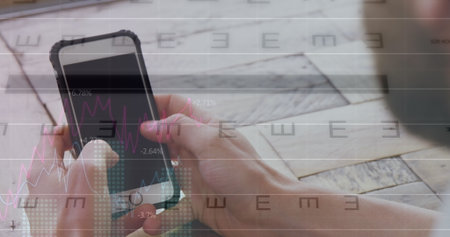 Holding smartphone case and analyzing overlaid stock charts on wooden desk at workspace, copy space....