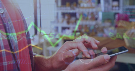 Adult male hands holding smartphone in cafe, wearing plaid shirt with digital stock market overlays....