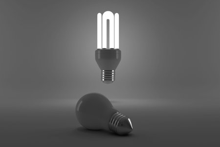Lit energy efficient lightbulb over bulb on gray backgroundの写真素材