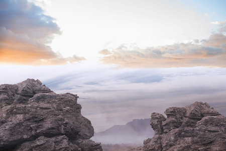 Jagged rocks in flat design are standing on summit revealing cloud inversion under pastel sky....