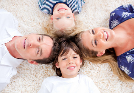 Cheerful family lying in circleの写真素材