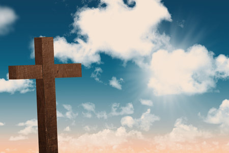 Wooden Christian cross is standing in flat design against cloudy sky, casting soft sunlight rays. Religion, spirituality, faith, religious symbol, outdoor, sky, serenityの写真素材