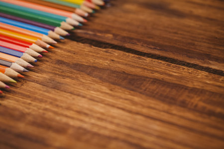 High angle view of color pencils on wooden tableの写真素材