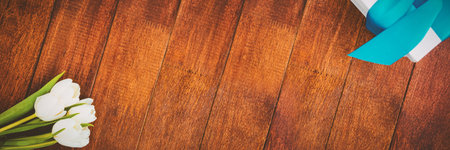 Flowers on wood floor with giftsの写真素材