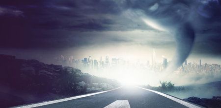 Flat design showing two lane road marked lines leading to stormy city skyline under tornado funnel....
