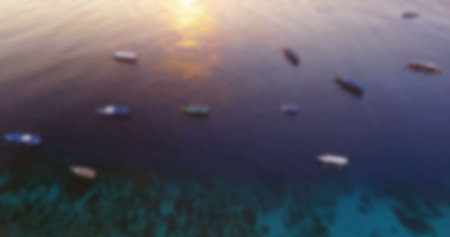 Aerial view of boats moored on sea during sunset