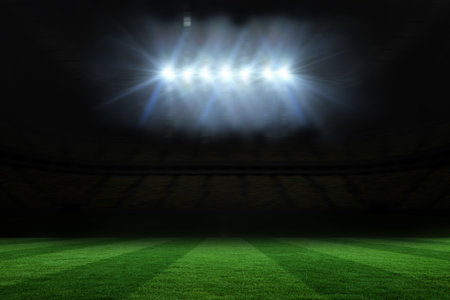 Digitally generated football pitch under spotlightsの写真素材
