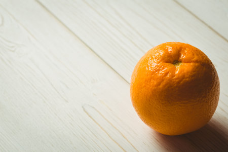 Close-up of orange fruit on wooden tableの写真素材
