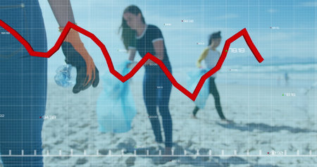 Volunteers collecting litter on sandy beach, grid overlay and red line graph data, copy space....