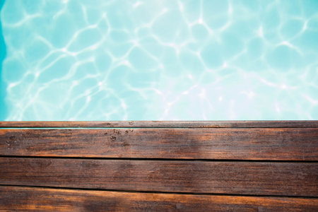 High angle view of wooden pier by swimming poolの写真素材