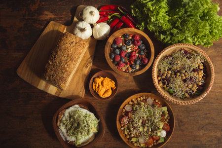 High angle view of bread and berry fruits on table in kitchen at homeの写真素材