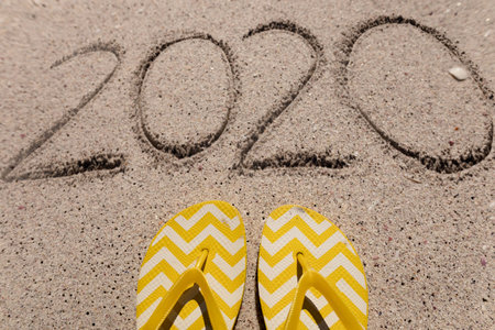 Beach holiday with 2020 in the sand