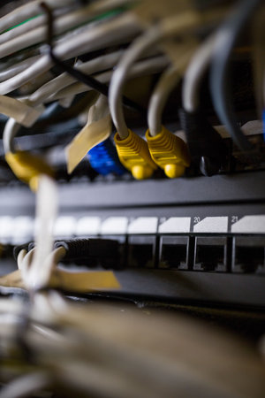 Colorful Ethernet cables are connecting to rack switch in flat design, showing port labels....
