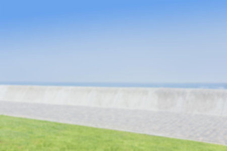 Walkway by beach against clear blue skyの写真素材