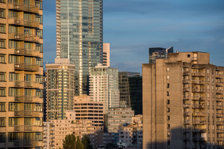 Sunlight falling on modern buildings against sky during sunny day