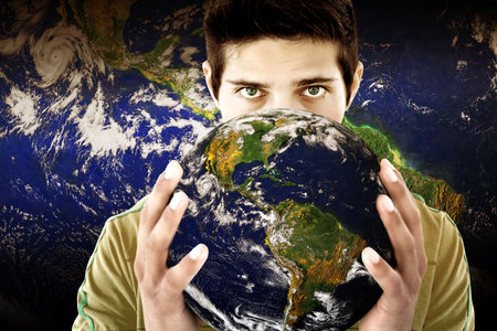 Adult male is holding realistic globe with Americas and clouds in composite space backdrop. Globes,...