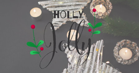 Displaying glittered star ornaments, lit tealights, pine and holly under HOLLY Jolly on tabletop. Festive, holiday decor, seasonal, celebration, cozy, winter, sparkleの写真素材