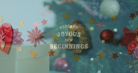 Showcasing lettering HERE'S TO JOYOUS NEW BEGINNINGS in shop window, with stars and tree silhouette. Festivity, celebration, warmth, elegance, seasonal, dÃ©cor, sparkleの写真素材