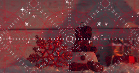 Displaying snowman figurine wearing black top hat, red scarf at home, with red snowflake ornament. Festive, holiday, seasonal, decor, cozy, sparkle, winterの写真素材