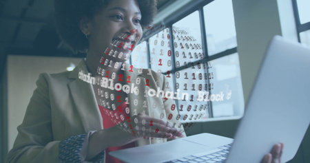 Presenting woman in blazer gesturing at rotating blockchain globe hologram in office holding laptop....