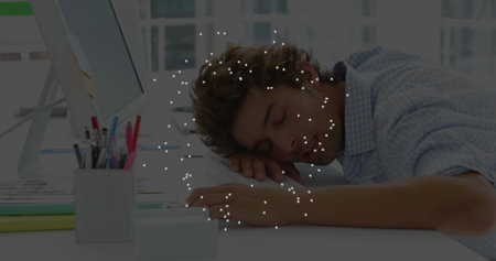 Leaning forward office worker dozing on arms at office desk, with monitor and folders, copy space....