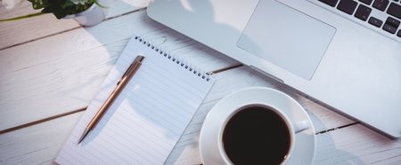 High angle view of laptop with book and coffee cup on table