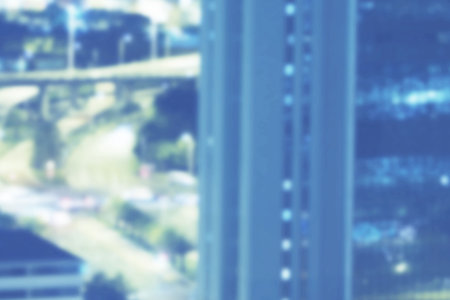 Flat design showing blurred city view with glass skyscraper facade, highway overpass and cars....