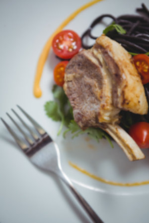 High angle view of lamb chop in plate on tableの写真素材