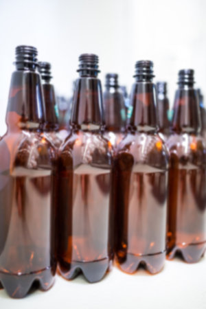 Close-up of beer bottles in row at factoryの写真素材