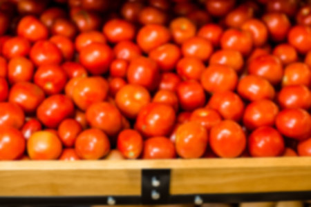Tomatoes on wooden shelf for sale at supermarketの写真素材