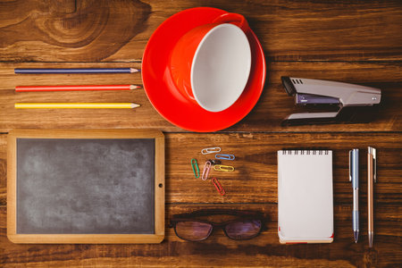 Flat design illustration is showing overhead wooden desk featuring chalkboard, red cup, stationery. Stationery, workspace, organization, craft, creativity, office, accessoriesの写真素材