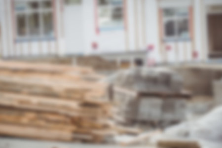 Defocused image of wooden planks and stones at construction siteの写真素材