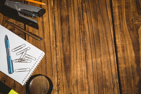 Overhead view of office supply on wooden table