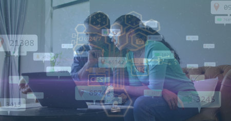 Analyzing couple exploring floating data overlays on laptop in living room, with sofa and plant....