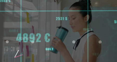 Asian woman in blouse holding mug analyzing currency figures on sticky notes in office, copy space....