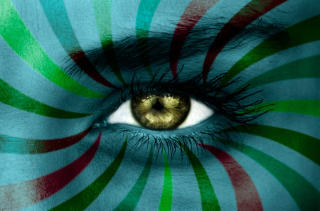 Green eye on patterned face of stripesの写真素材