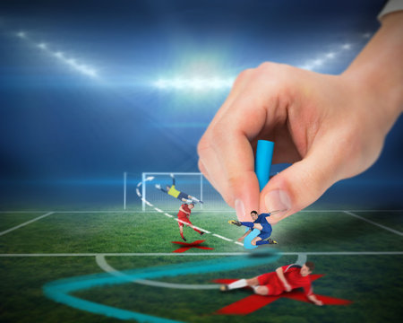 Digital composite of hand drawing tactics on football pitch during matchの写真素材