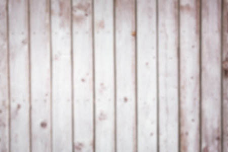 Vertical wooden planks are showing weathered brown spots in flat design with faded paint and blur. Rustic, textured, aged, antique, natural, distressed, vintageの写真素材