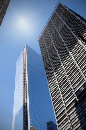 Low angle view of skyscrapers under blue sky