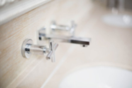 High angle view of modern metallic faucet in bathroomの写真素材