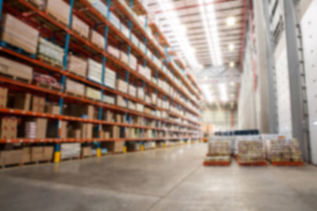 Cardboard boxes arranged on rack in distribution warehouse