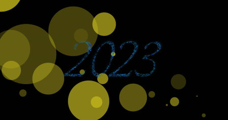 Displaying stylized blue glitter 2023 overlapping translucent yellow circles on black canvas, bokeh....