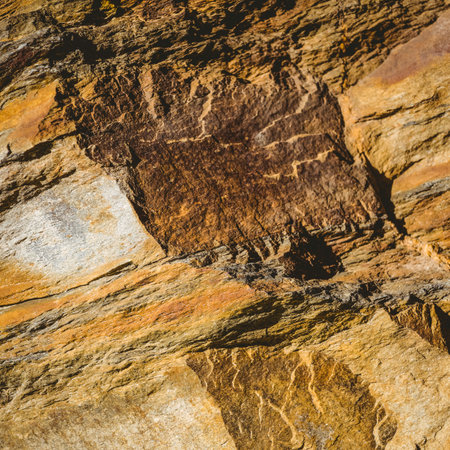 Sedimentary rock outcrop is showing layered strata in flat design, with mineral veins and fissures. Geology, erosion, stratification, mineralogy, outdoor, naturalformation, landscapeの写真素材