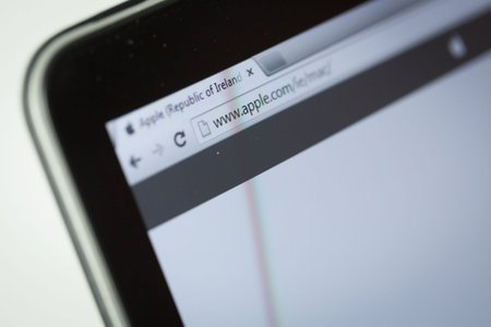 Apple website on tablet screen over white background